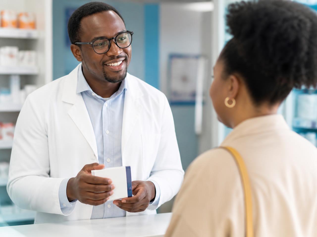 A Litien Pharmacy pharmacist giving friendly advice to a customer